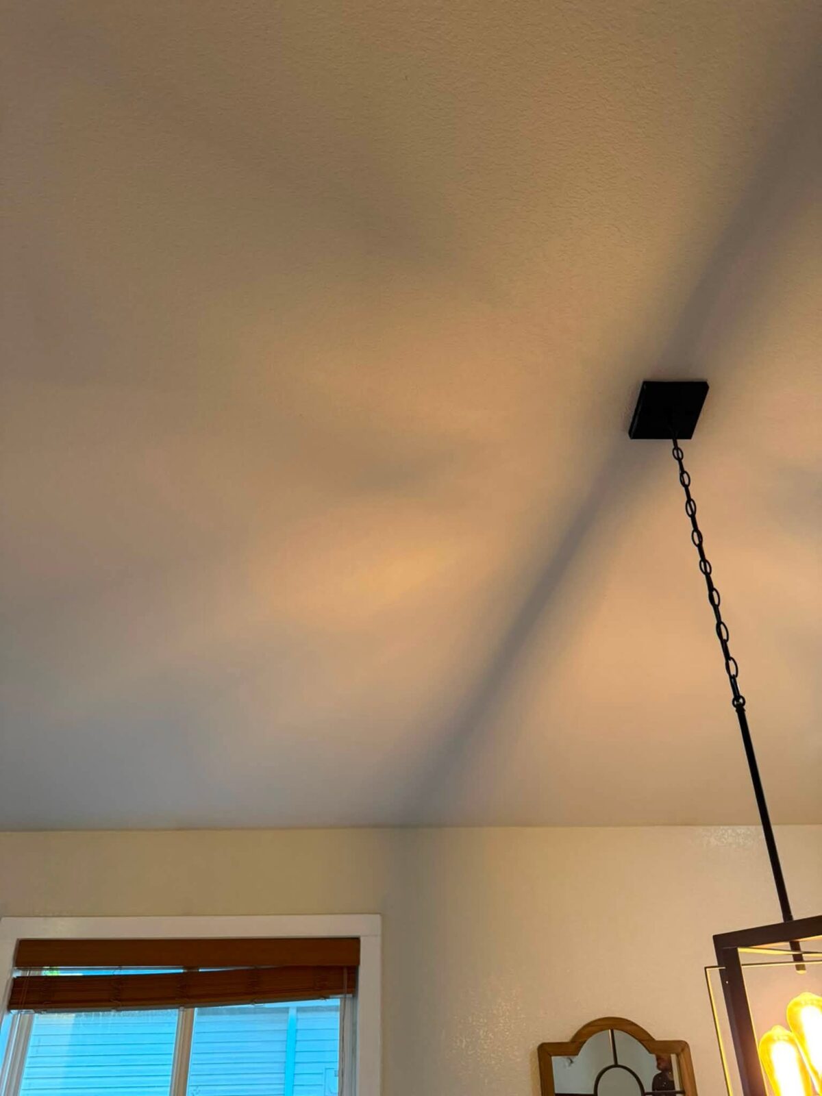 The same vaulted ceiling after patching, with the texture matched seamlessly